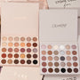 Bold + Bare ColourPop Shadow Palette Set displaying two open 30-pan palettes - warm neutrals and coppers on the left, cool taupes, mauves, and charcoals on the right - with matte and shimmer finishes, on a beige background with branded sleeves.