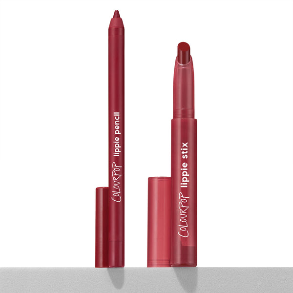 Read My Lips ColourPop Lippie Stix + Pencil Set stands uncapped, showing a berry-red lip pencil and matching Lippie Stix bullet with caps beside them on a clean white surface under studio light, sleek red tubes highlighting the lipstick and liner duo.