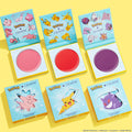 Electrifying Dreams ColourPop Cream Blush set presenting three open pans - soft pink, bright red, and deep purple - inside teal Pokémon-themed compacts, with matching boxes showing Clefairy, Pikachu, and Gengar on a bright yellow background.