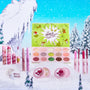 ColourPop x The Grinch Full Collection Set arranged on a snowy Whoville backdrop - open lime-green palette with 15 matte and shimmer shades and the quote “The Grinch got a wonderful awful idea!”, surrounded by pink lip crayons, glosses, highlighters, and glitter; holiday Colourpop makeup.