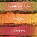 ColourPop Shadow Stix Love Triangle bundle swatches showing three metallic shades - It’s Always Been Him (pink‑green duochrome), Wolf Girl (copper gold), and Vampire Girl (rosy plum) - spread in horizontal strips on a textured makeup surface.