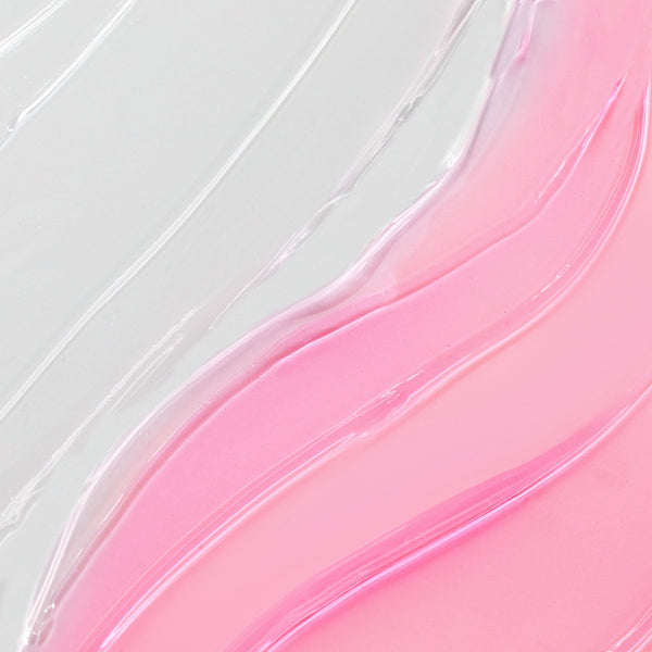 Plump Perfect So Juicy Lip Oil Set swatches gleam in curved streaks of clear to rosy pink on a smooth white surface, showcasing the glossy, hydrating finish of the ColourPop So Juicy Lip Oil Set.