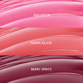 ColourPop So Juicy Plumping Gloss Balm with Peptides swatches showing She’s So Juicy shades: Dolled Up (bright pink), Guava Glaze (coral peach), and Berry Spritz (deep berry), displayed as glossy curved stripes in a close-up bundle layout.