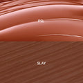 Swatches show a glossy terracotta balm labeled PSL over a matte deep cocoa liner labeled SLAY, demonstrating shade and texture of the Smooches ColourPop So Juicy Plumping Lip Liner & Balm Set, with smooth curved balm streaks and fine liner strokes.