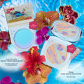Crowd Favorite Instant Crush Cream Blush compact opens to reveal an aqua-blue, pH-powered formula that shifts to a custom pink flush, styled poolside with orchids and a Stitch beach motif, beside the ColourPop Super Shock Highlighter.