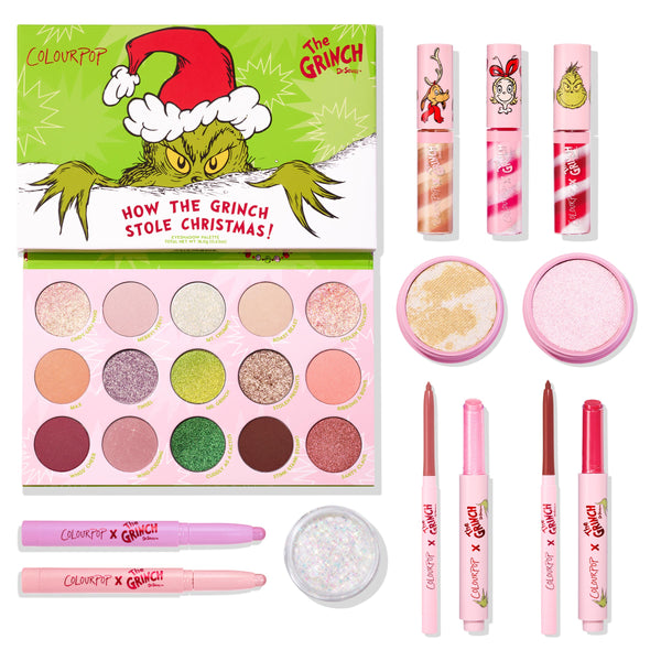 ColourPop x The Grinch full collection set displayed on white, featuring an open 15‑shade eyeshadow palette plus three lip glosses, two highlighters, two shadow sticks, glitter gel, and three lippie stix in pink holiday packaging by ColourPop.