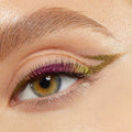 Pixie shade of the ColourPop Chrome Crème Gel Liner tracing a sharp metallic cat-eye on a hazel eye, shifting green to gold with pink‑lime iridescence along the lash line, close-up to show creamy payoff, high shine, and precise winged detail.