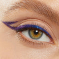 Shifting blue-to-violet winged liner defines the upper lash line and extends into a sharp double wing, showcasing Ventura Blvd, a ColourPop Chrome Crème Gel Liner, on a close-up eye with soft natural lashes and brow.