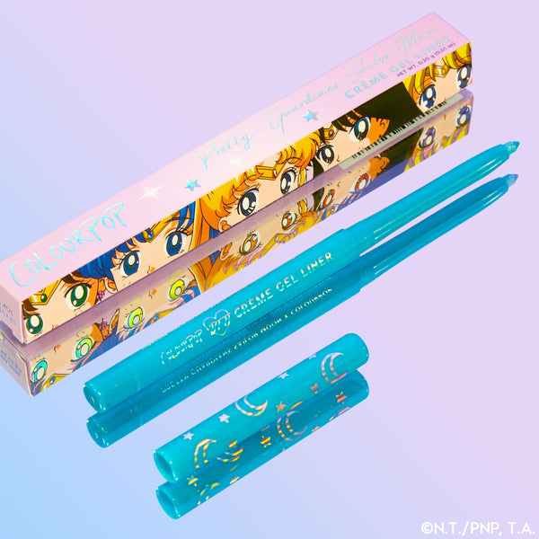 ColourPop Crème Gel Liner “Crystal Tokyo” shown uncapped, two teal twist-up pencils revealing bright aqua gel tips with moon-and-star printed caps, placed beside the Sailor Moon collab box on a purple-to-blue gradient background.