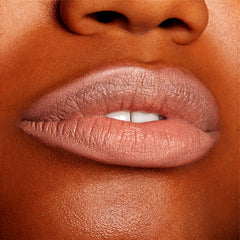 Close-up lips wearing BFF, lined and softly filled with ColourPop Lippie Pencil, showing a creamy matte peachy‑nude shade with precise edges and smooth texture against warm brown skin in a studio setting.