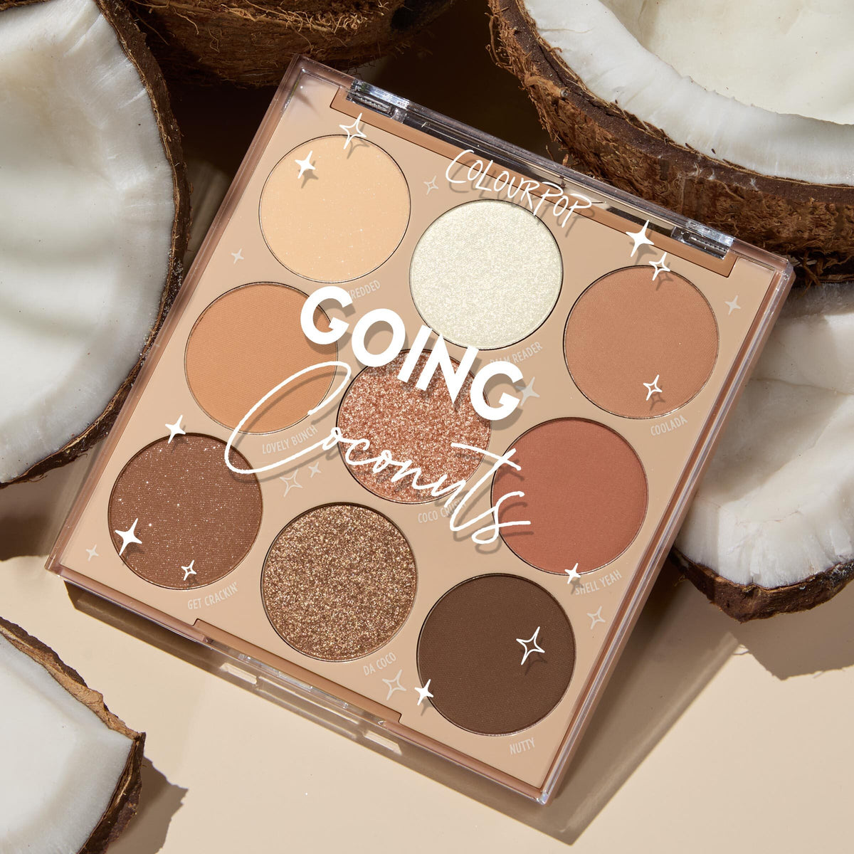 ColourPop Shadow Palette Going Coconuts lies open to reveal a 9βpan 3x3 grid of warm neutral browns and champagnes in matte and shimmer finishes, styled among cracked coconut halves on a beige surface.