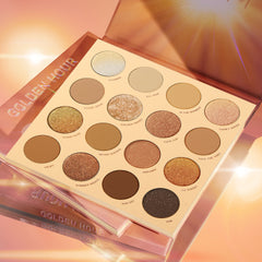 Golden Hour ColourPop Shadow Palette opened to 16 warm-tone pans - mattes and metallic gold, bronze, and copper shimmers like Glimmer, Golden Waves, and LA Sunset - sparkling under sun flares on a glossy peach background with stacked packaging.