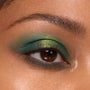 Eyelid showcasing a metallic lime-to-emerald green gradient from the Rainbow Rush Shadow Palette Set, ColourPop green eyeshadow look, with soft mascara and a defined brow in a tight close-up.