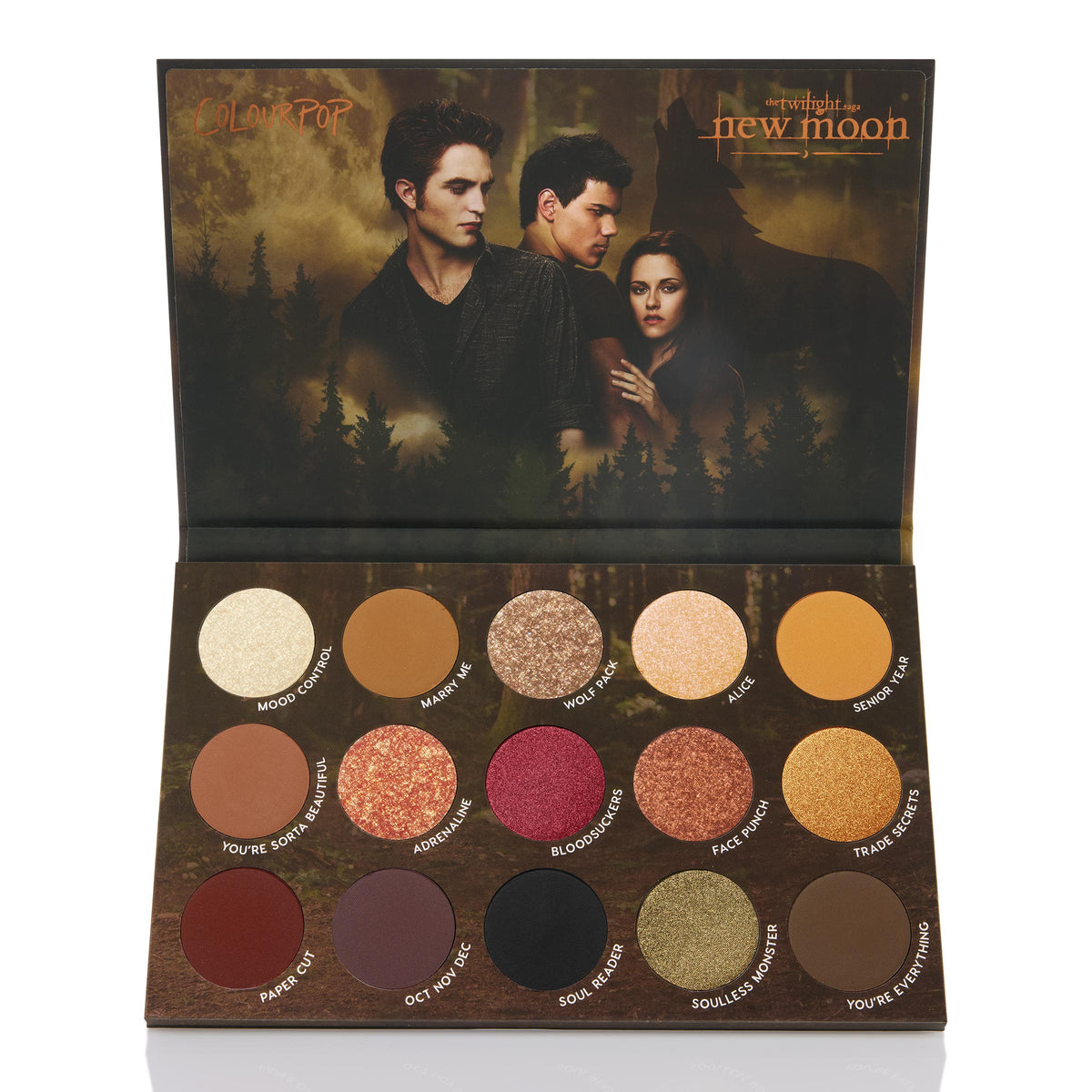 New Moon ColourPop Shadow Palette opens to a 15-pan mix of warm neutrals, golds, coppers, and berry tones in matte, shimmer, and metallic finishes, each shade labeled, set against Twilight Saga: New Moon forest artwork with three characters on the lid.