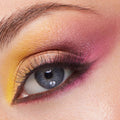 Sunset gradient eye makeup blending matte yellow inner corner, gold shimmer lid, and magenta‑plum crease and lower lash line on natural lashes, created with the Partner Up ColourPop Shadow Palette & pH Lipstick Set for bold, blendable color.