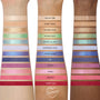 ColourPop Disney Lilo and Stitch Collection full collection set arm swatches displaying 12 eyeshadow shades - nudes, greens, teals, blues, purples, pinks, coral, and red - in matte and shimmer, labeled on three skin tones.