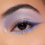 Shimmery lavender-to-blue winged eyeshadow accenting a brown eye, with an iridescent inner corner and lilac lower lash line, showcasing shades from the Disney Lilo and Stitch Collection ColourPop Full Collection Set in a close-up beauty shot.