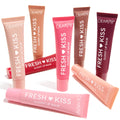 Eight ColourPop Fresh Kiss Glossy Lip Balm tubes fan out on white, some upright and one laid across, displaying nude, pink, coral, red, brown, and berry shades; Gloss Goals Full Collection Set, a ColourPop Full Collection Set for shiny, hydrated lips.