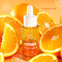 Fourth Ray Beauty Raydiate Vitamin C Serum 1 fl oz dropper bottle glistens with dew among fresh orange slices on a bright citrus background, highlighting brightening in the Get That Glow ColourPop Face Set.