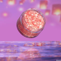 Floating Lights glitter gel jar hovers tilted above rippled water, its rosy-pink, chunky iridescent sparkles shining against a purple background with lantern bokeh; ColourPop Glitter Gel for face and body shown open, no lid.