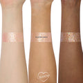 Floating Lights glitter gel from the Disney Tangled and ColourPop Collection swatched on three skin tones, showing the iridescent pink and gold sparkles of this Back In Stock ColourPop full collection set shade.