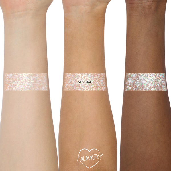 ColourPop Who-Hash Glitter Gel swatched in wide bands on three forearms - light, medium, and deep skin tones - showing iridescent, multi-size pink-gold-mint sparkle, with the shade name labeled on the center swatch.