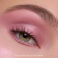 Close-up of a hazel eye wearing Heart to Get Love At First Swipe Shadow Stix, showing shimmery rose-pink eyeshadow blended from lash line to brow for a soft, romantic makeup look on smooth skin.