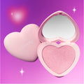 Heart to Get Not Your Baby Super Shock Blush compact lying open to reveal a shimmering pink heart-shaped blush pan and mirror in a pastel pink heart case against a dreamy purple gradient background with soft glowing stars, ColourPop logo visible.