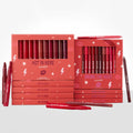 Heat Warning ColourPop Lippie Vault Set displays two coral boxes - Hot In Here Lippie Stix and Bring The Heat Lippie Pencil - showcasing red, berry, and nude shades, with extra sticks and pencils scattered on a white studio surface.