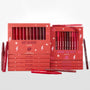 Heat Warning ColourPop Lippie Vault Set displays two coral boxes - Hot In Here Lippie Stix and Bring The Heat Lippie Pencil - showcasing red, berry, and nude shades, with extra sticks and pencils scattered on a white studio surface.