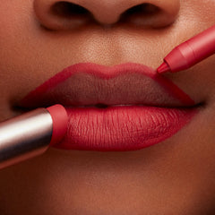 ColourPop Lippie Pencil in Bossy lining lips in a crisp, vivid red while a matching lipstick fills the bottom lip, shown in an extreme close-up for precise definition and creamy matte payoff.