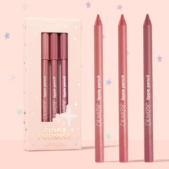 Pinky Promise ColourPop Lippie Pencil trio stands upright, three creamy lip liners in nude pink, rosy coral, and mauve berry beside a blush, star-embossed box on a pastel pink backdrop, limited edition set.