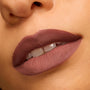 Matte mauve lips wearing Bella! Where the Hell Have You Been, Loca? Power Pout Lipstick, showing full, velvety coverage with defined edges, captured in an extreme close-up on warm skin - ideal for completing a ColourPop Lip Set.