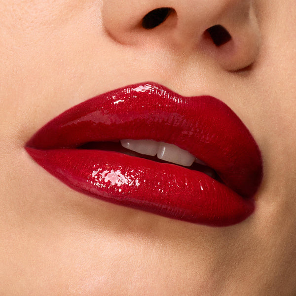 Glossy cherry-red lips showcase Pack Member ColourPop Lip Set, delivering rich pigment and a high-shine finish, captured in an extreme close-up against smooth skin for a bold, vampy look.