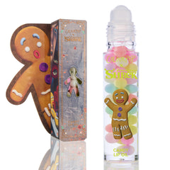 Gumdrop Buttons ColourPop Candy Lip Oil displayed with rollerball applicator, clear tube featuring pastel gumdrop visuals and a smiling gingerbread man, set beside a Shrek collab box with cookie-shaped cutout.
