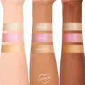 Pink Pony ColourPop Liquid Highlighter swatched on three arms, showing a luminous pink pearl sheen between shades Sugar Donut and Immediately, Yes; reflective shimmer across light, medium, and deep skin tones for easy shade comparison.