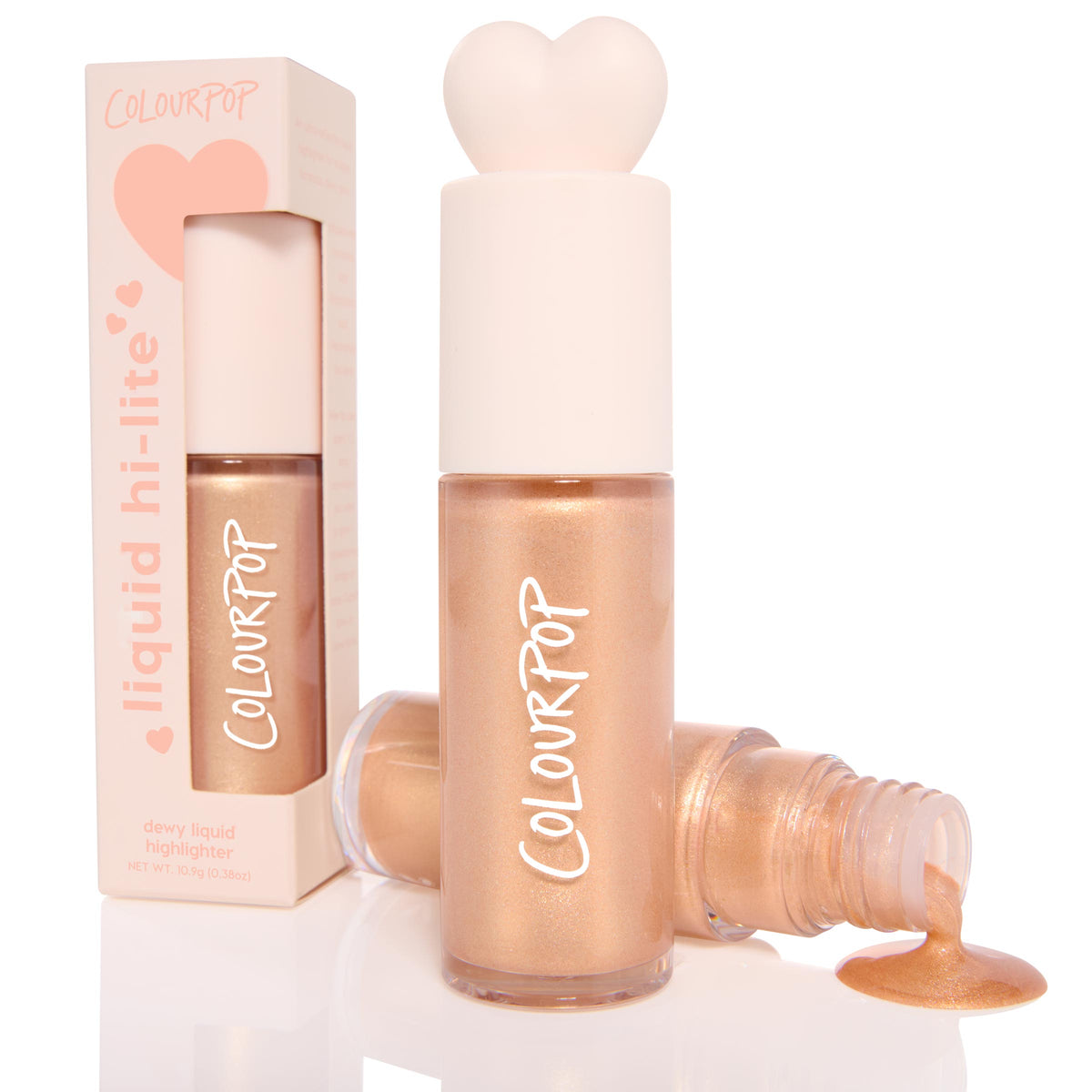 Immediately Yes ColourPop Liquid Highlighter in a clear tube with a cream heart-shaped cap, one bottle standing by its carton while another lies open, spilling pearly champagne-gold shimmer onto a white surface to showcase the dewy liquid hi-lite.