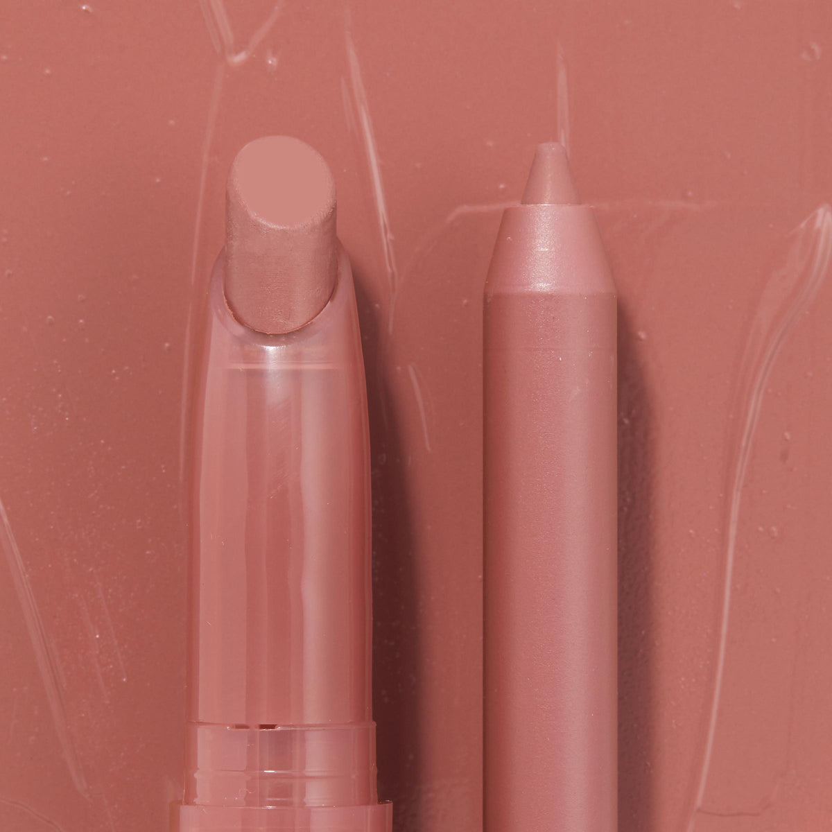Double the Trouble ColourPop Lippie Stix + Pencil Set shown side by side in a warm rosy nude; the twist-up Lippie Stix and matching precision pencil rest on a glossy pink swatched backdrop, highlighting the coordinated shade for lining and filling lips.