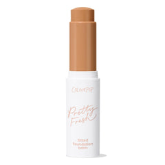 ColourPop Pretty Fresh Tinted Foundation Balm in Medium Dark 16, stick bullet extended from a white tube with rose-gold lettering, standing upright with cap off against a clean white background.
