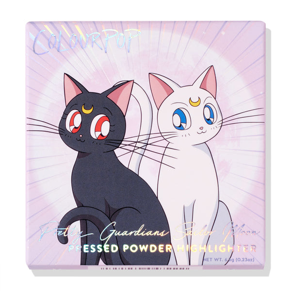 Moon Kingdom ColourPop Pressed Powder Highlighter compact featuring Luna and Artemis artwork, holographic Pretty Guardians Sailor Moon lettering, and pastel-lilac moonburst packaging; 0.23 oz pressed powder highlighter for luminous glow.