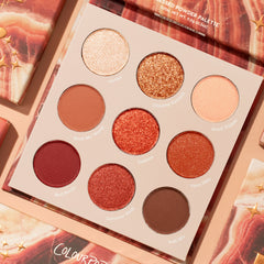 Rock On ColourPop Shadow Palette displaying nine warm, desert-inspired shades: Vortex, Chasing Sunsets, Road Trippin', Rock My World, Sedona, Fave Hike, Red Rocks, Summer Heat, Trail Mix, in matte and glitter finishes, set on peach marbled packaging.