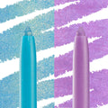 Tokyo Love ColourPop Crème Gel Liner standing with tip exposed beside a second shimmery shade, with bold swatches behind - aqua on the left and lilac on the right - showing creamy, glitter-flecked payoff for precise eye looks.