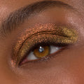 Wolf Girl ColourPop Shadow Stix creates a molten copper-to-gold duochrome on the eyelid, shimmering across the lid and crease with fine sparkle and defined lashes, macro beauty shot showing product payoff and metallic finish.