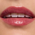 Glossy pink lips wearing ColourPop Ultra Glossy Lip, shade Short Lord, delivering a sheer rosy tint with mirror-like shine; close-up beauty swatch on smooth skin highlights the plush texture and reflective finish.
