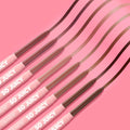 ColourPop So Juicy Plumping Lip Liner Set, Juiciest Pout, fans diagonally and draws curved swatches across a bright pink backdrop, showing eight retractable pencils in nude, rose, mauve, and deep brown tones with SO JUICY branding on pink barrels.