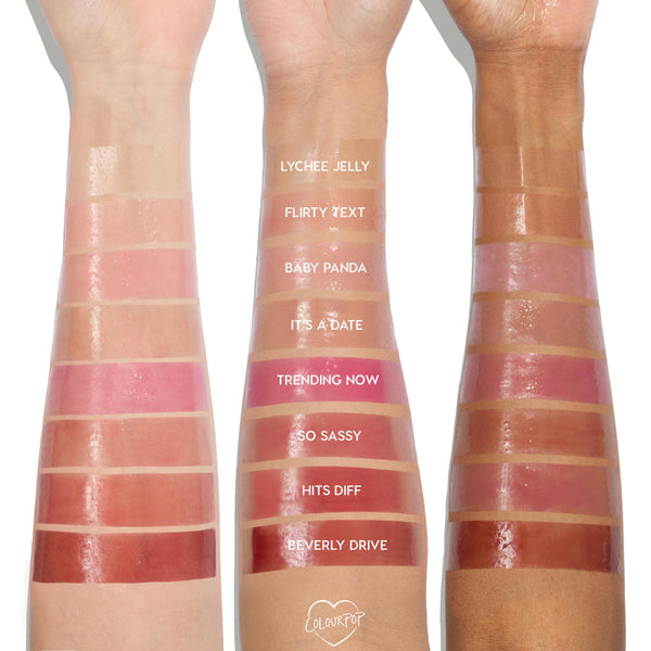 Three forearms display Plump Perfect swatches from the ColourPop So Juicy Lip Oil Set, showing glossy shades Lychee Jelly, Flirty Text, Baby Panda, It’s a Date, Trending Now, So Sassy, Hits Diff, and Beverly Drive on light, medium, and deep skin tones.