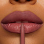 ColourPop So Juicy Plumping Lip Liner with Peptides in ETA defining glossy rosy‑mauve lips, pencil tip centered on the cupid’s bow in an extreme close‑up, showing smooth precise payoff for lip shaping and plumping.