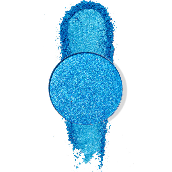 Round Tide Pool ColourPop Pressed Powder Shadow pan displays vibrant metallic ocean‑blue pigment, with a thick swipe of the shimmery powder dragged vertically beneath the pan on a white background.