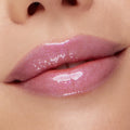 Glossy lips wearing sheer pink‑lilac shimmer, showcasing the Type Advantage Lip Set, a ColourPop Lip Set, in a studio close-up that highlights the smooth texture and glassy, high-shine finish.