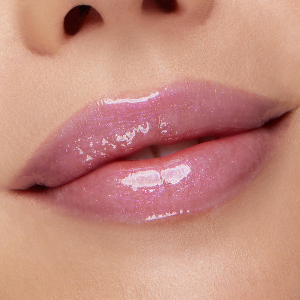 Glossy lips wearing sheer pink‑lilac shimmer, showcasing the Type Advantage Lip Set, a ColourPop Lip Set, in a studio close-up that highlights the smooth texture and glassy, high-shine finish.